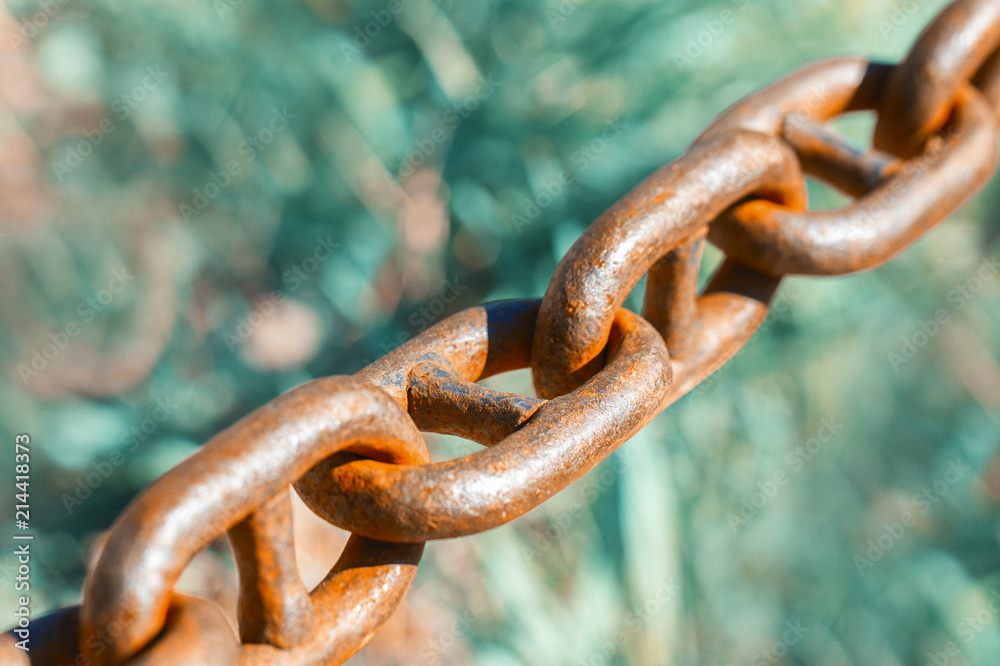 Old metal chain on green background Horizontal Old metal chain on green background Horizontal