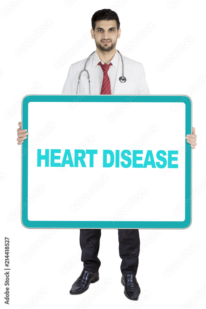 Arabian doctor holding heart disease text on studio