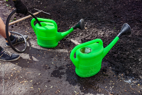 green watering can for watering flowers