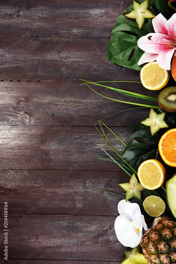 Assortment of tropical fruits with leaves of palm trees and exotic plants Assortment of tropical fruits with leaves of palm trees and exotic plants