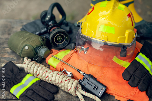 Outfit of Firefighter placed on nature background, Fire equipment concept.