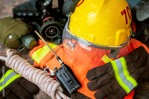 Outfit of Firefighter placed on nature background, Fire equipment concept.