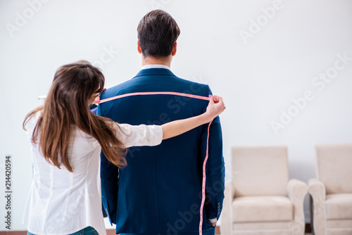 Konstfotografi Professional tailor taking measurements for formal suit