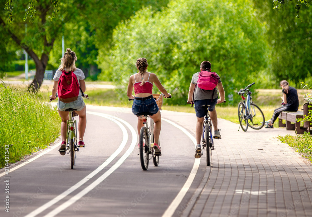Fototapeta premium Cyclists ride on the bike path in the city Park 