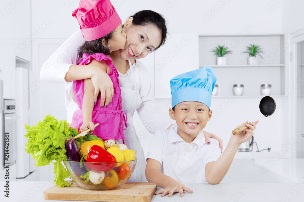 Happy mother and kids with vegetables Happy mother and kids with vegetables