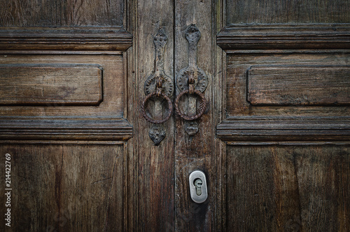 Old vintage retro style wood door with rusty handles background and texture. © torjrtrx