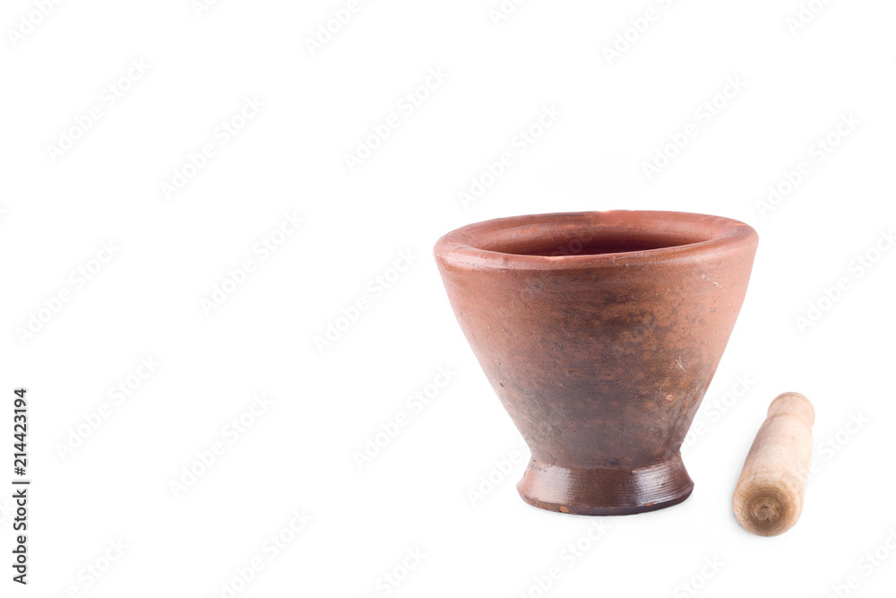 Clay mortar and wood pestle is used to mix the ingredients on white background  cooking kitchenware object isolated
