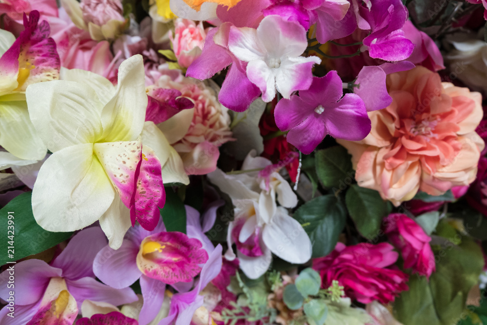 Beautiful multicolored artificial flowers background. Fake fabric flowers decor. Beautiful multicolored artificial flowers background. Fake fabric flowers decor.