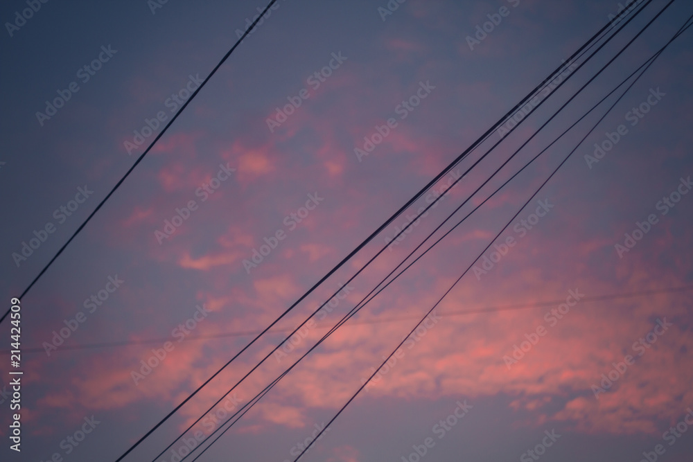 sunset against the background of electric wires