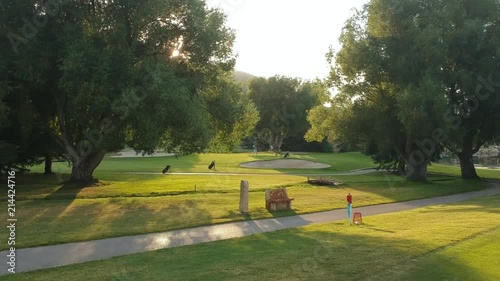 People playing casual golf at sunset. photo