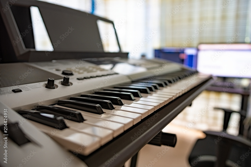 Electric piano in front of a working station Electric piano in front of a working station