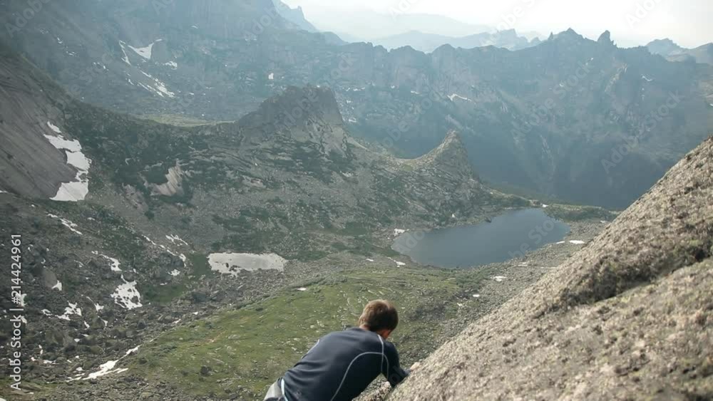 A brave man climbs to the top of the cliff without insurance. A brave man climbs to the top of the cliff without insurance.