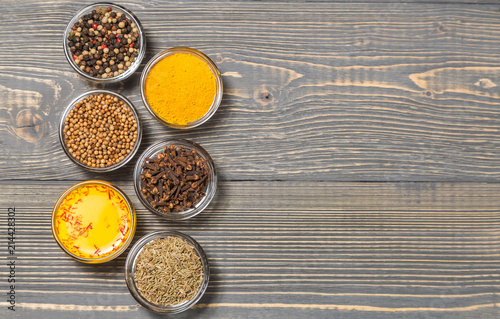 Spices for making curry sauce on a dark background. The view from the top. Copy-space.