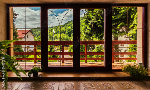 Beautiful views of the large, wooden windows that overlook the balcony