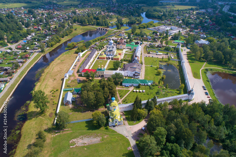 View from the heights to the Tikhvinsky Bogorodichny Uspensky Monastery on a sunny July afternoon (aerial photography). Tikhvin, Russia