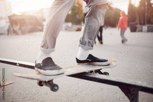 Male skateboarder performs tricks on ramp on skateboard. Concept street sports, bully © Parilov