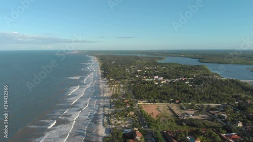 view from the sky of river and sea divided by island. canavieiras, bahia, brazil