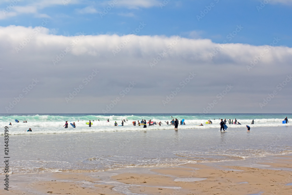 Surfers in sea in Cornwall