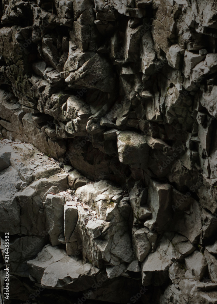 Closeup of a sedimentary mountain rocks texture. Rocks texture in light and shadow