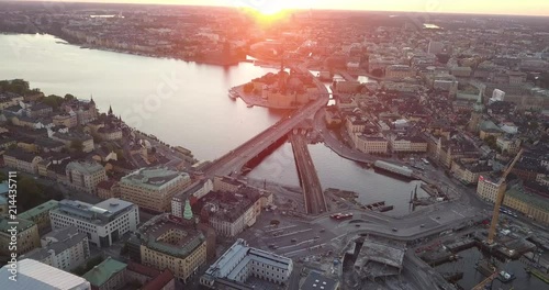 Aerial view of Stockholm during a majestic sunset. Drone orbits around buildings, cars and a beautiful canal. Looking over the Old Town of Stockholm Sweden. photo