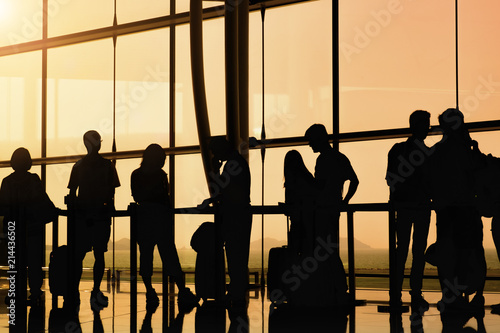 silhouette of people in queue waiting for check in at airport © Natee Meepian