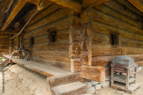 The old authentic Ukrainian hut, made of wooden beams with small windows in it