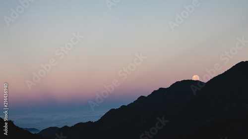 Moon behind the mountains
