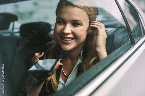 Tela Businesswoman making phone call in cab
