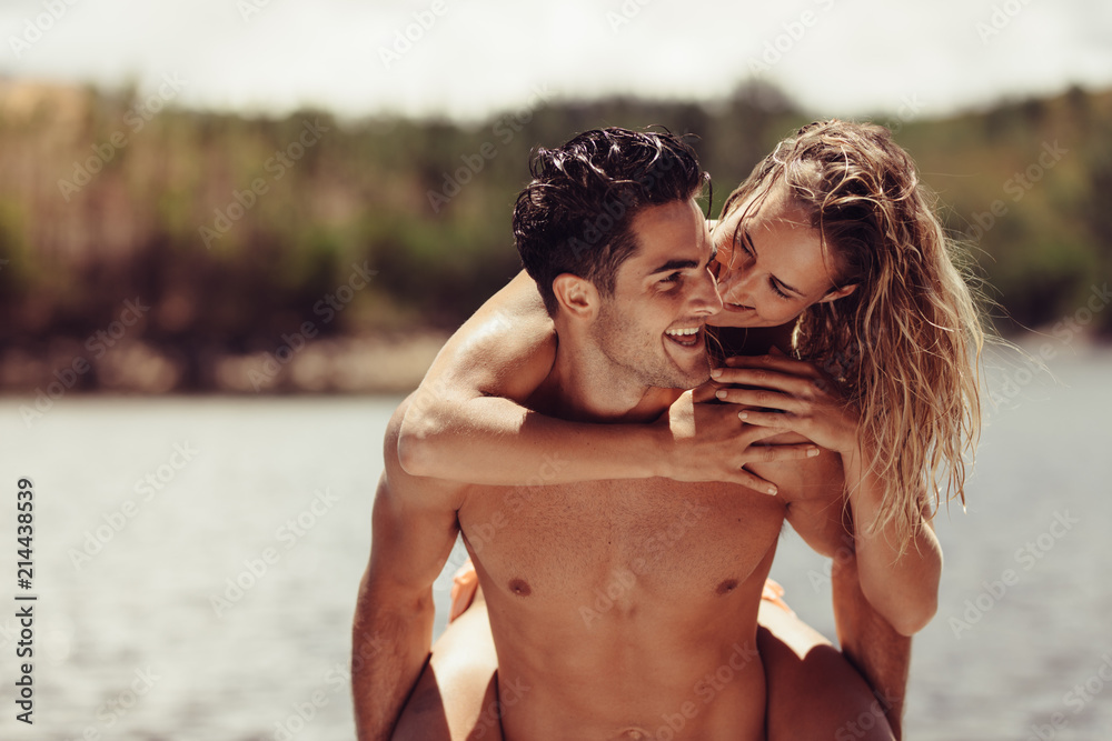 Romantic man piggybacking his girlfriend Romantic man piggybacking his girlfriend