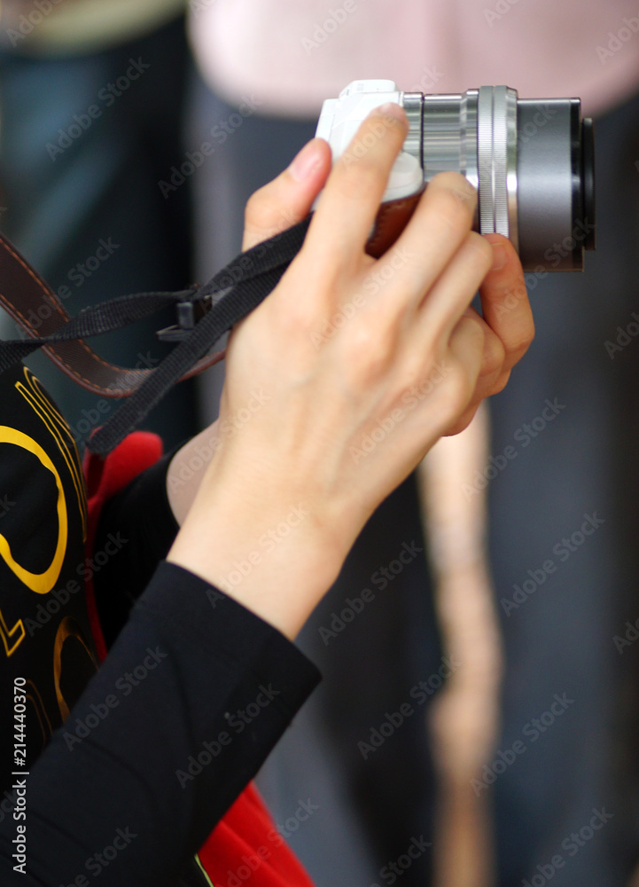 Closeup view of young photographer shooting with DSLR Closeup view of young photographer shooting with DSLR