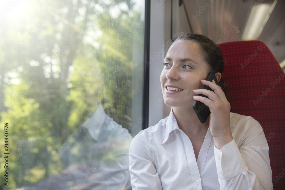 Businesswoman on the phone whilst travelling by train Businesswoman on the phone whilst travelling by train