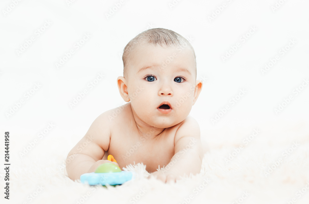 Small smiling baby with a toy Small smiling baby with a toy