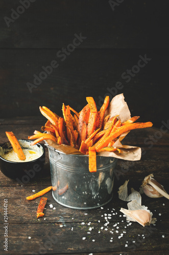 Sweet fried potatoes with spices, salt and sauce