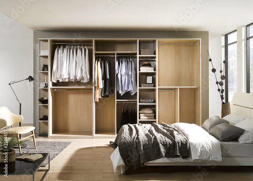 Big wardrobe with different clothes for dressing room. Interior structure of wardrobe body and shelf design.