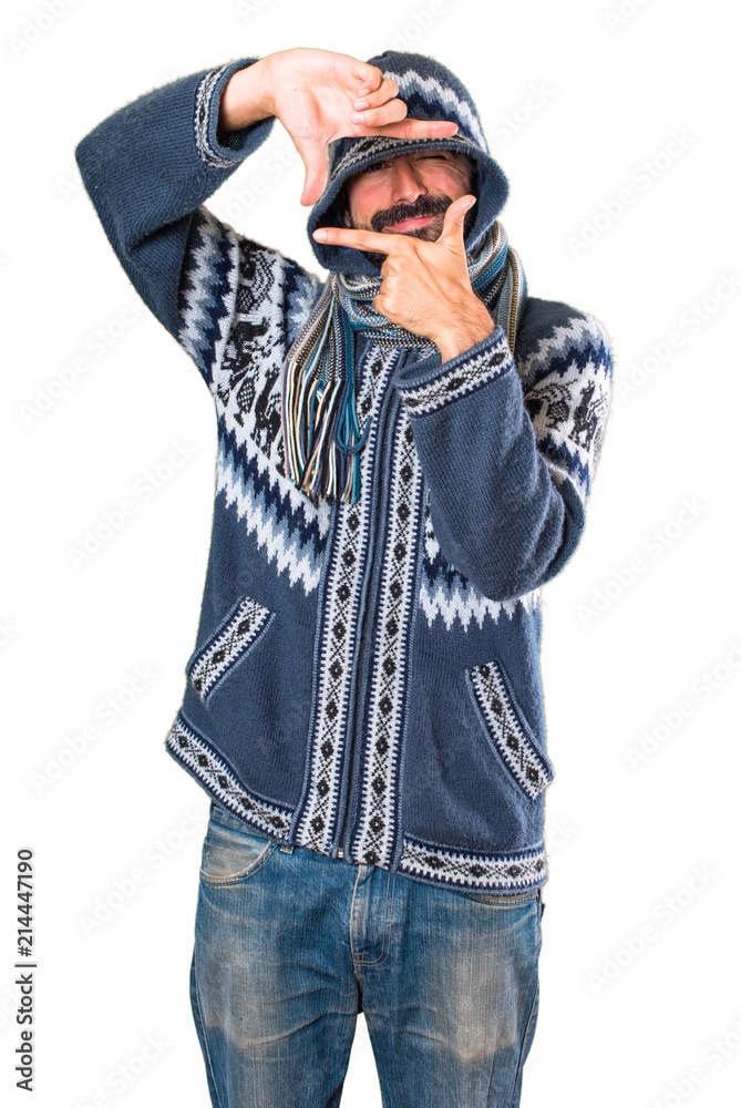Man with winter clothes focusing with his fingers Man with winter clothes focusing with his fingers
