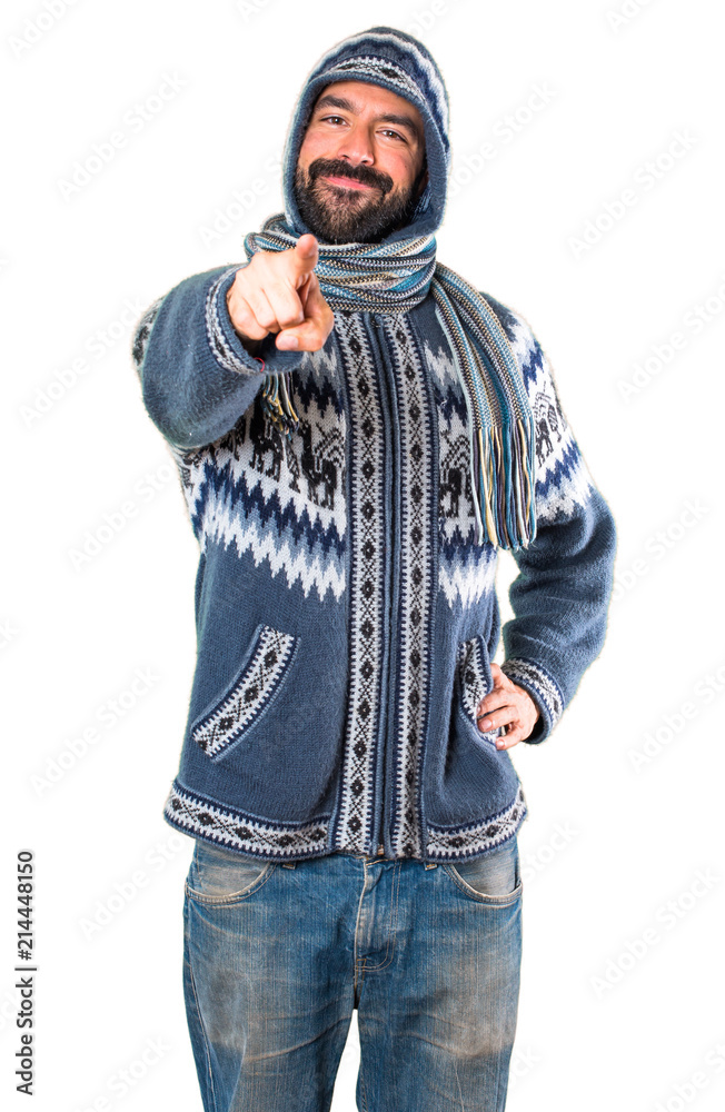 Man with winter clothes pointing to the front