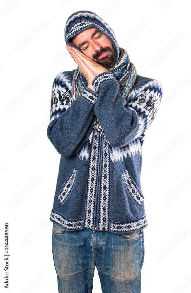 Man with winter clothes making sleep gesture