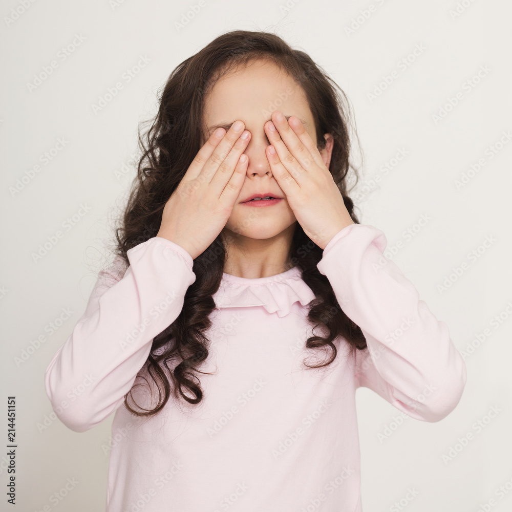 Little girl covering her eyes with hands Little girl covering her eyes with hands