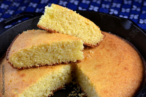 Homemade buttermilk cornbread served in a cast iron frying pan: close up, profile, selective focus. photo