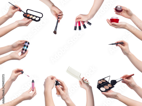 Set of makeup cosmetics in hands on white background