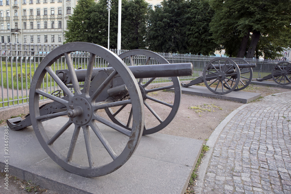 Old single barrel wheeled iron cannons of russian army of 19th century exposed on the city square