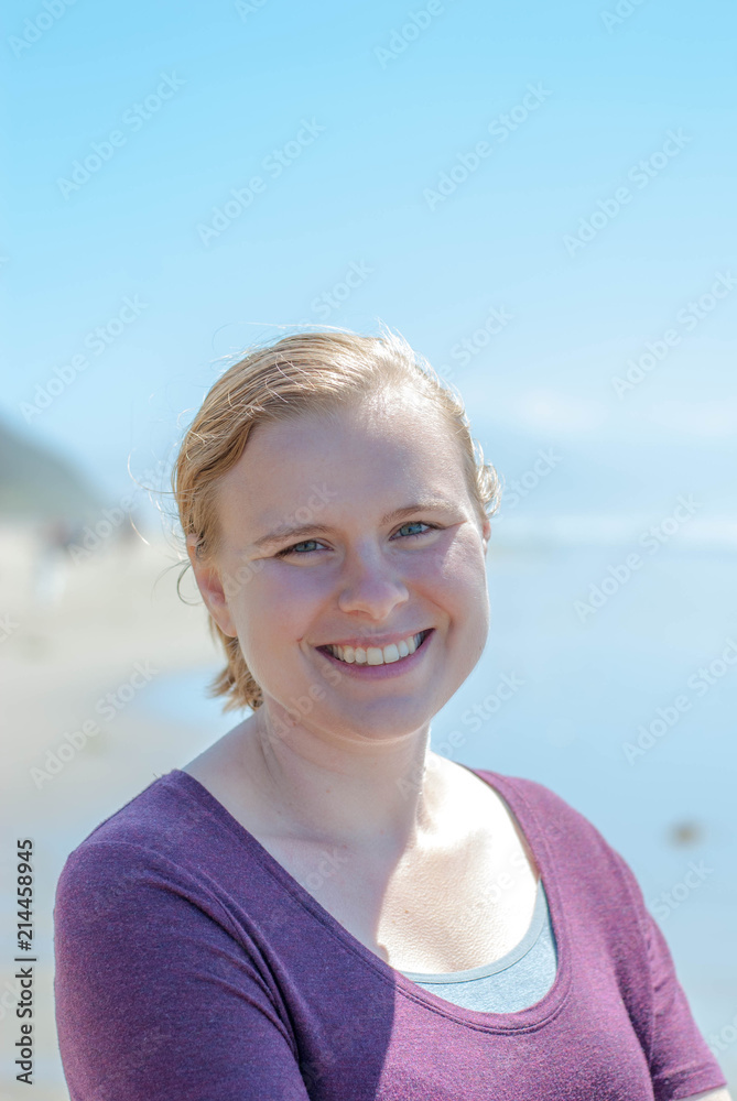Woman smiling with a beach background Woman smiling with a beach background