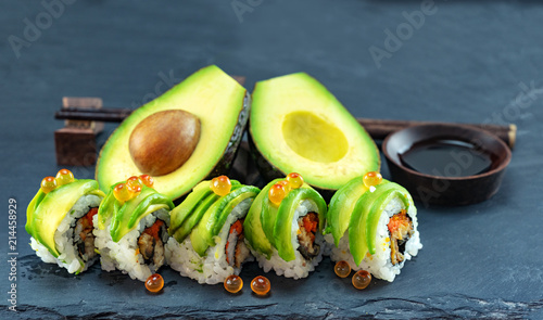 japanese avocado sushi set with shoyu source on black slate dish