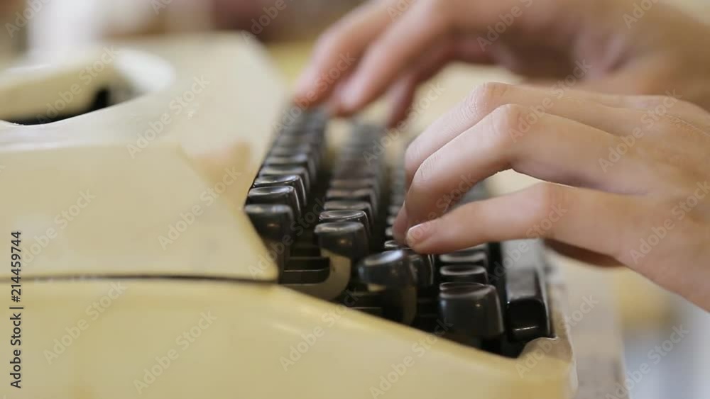 Writer typing with retro writing machine.