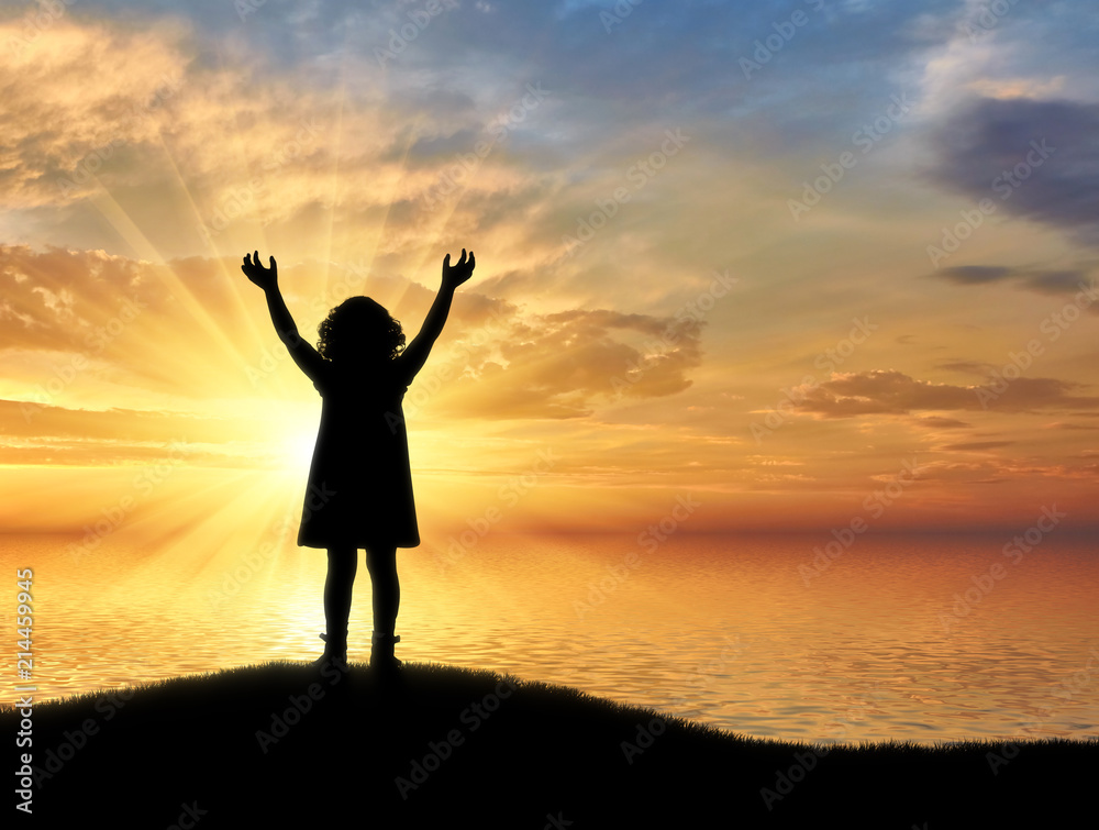 Silhouette, little happy baby girl standing on a hill near the sea on a background
