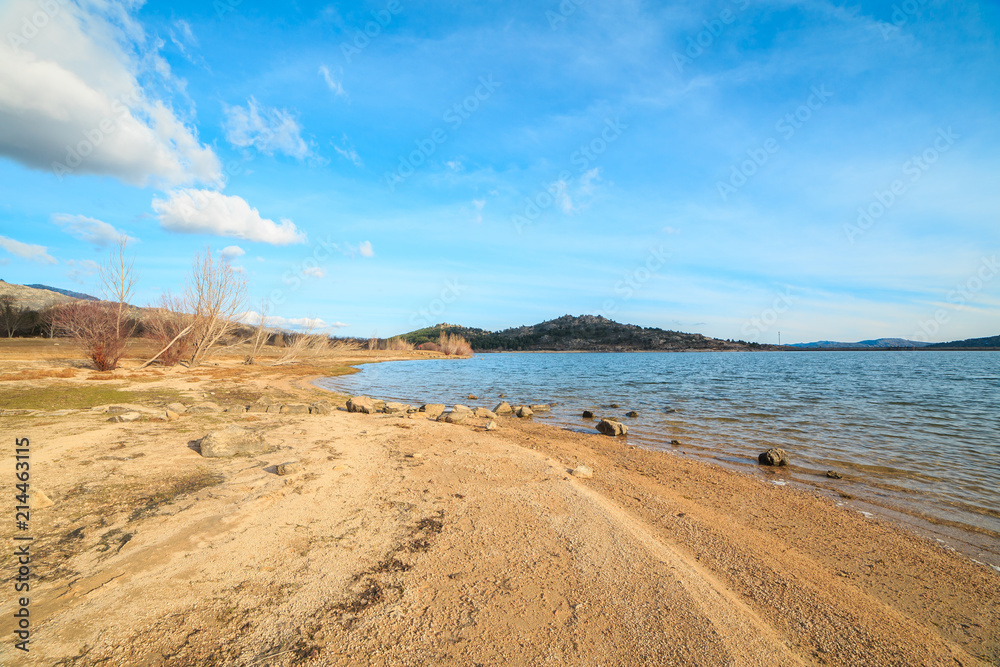 Beautiful lake in the mountains at sunset on a sunny day with blue sky Beautiful lake in the mountains at sunset on a sunny day with blue sky