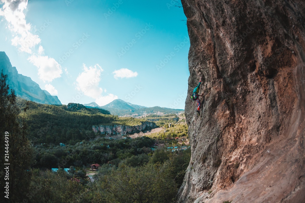 Naklejka premium A climber climbs the rock.