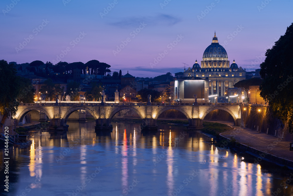 The blue hour view on gorgeous St. Peter's Basilica in the Vatican across the Tiber River in Rome, Italy
