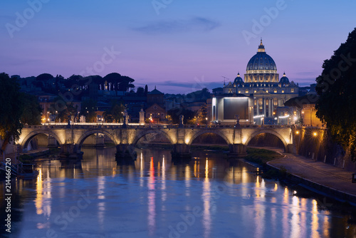 The blue hour view on gorgeous St. Peter's Basilica in the Vatican across the Tiber River in Rome, Italy