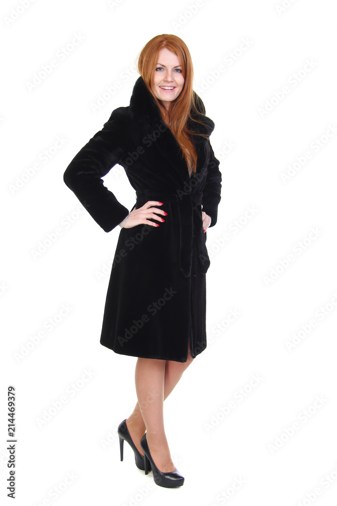 Redhead young woman in black fur coat isolated on white Redhead young woman in black fur coat isolated on white